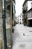 A pedestrian street in Santiago de Compostella with a decorative downpipe on the corner